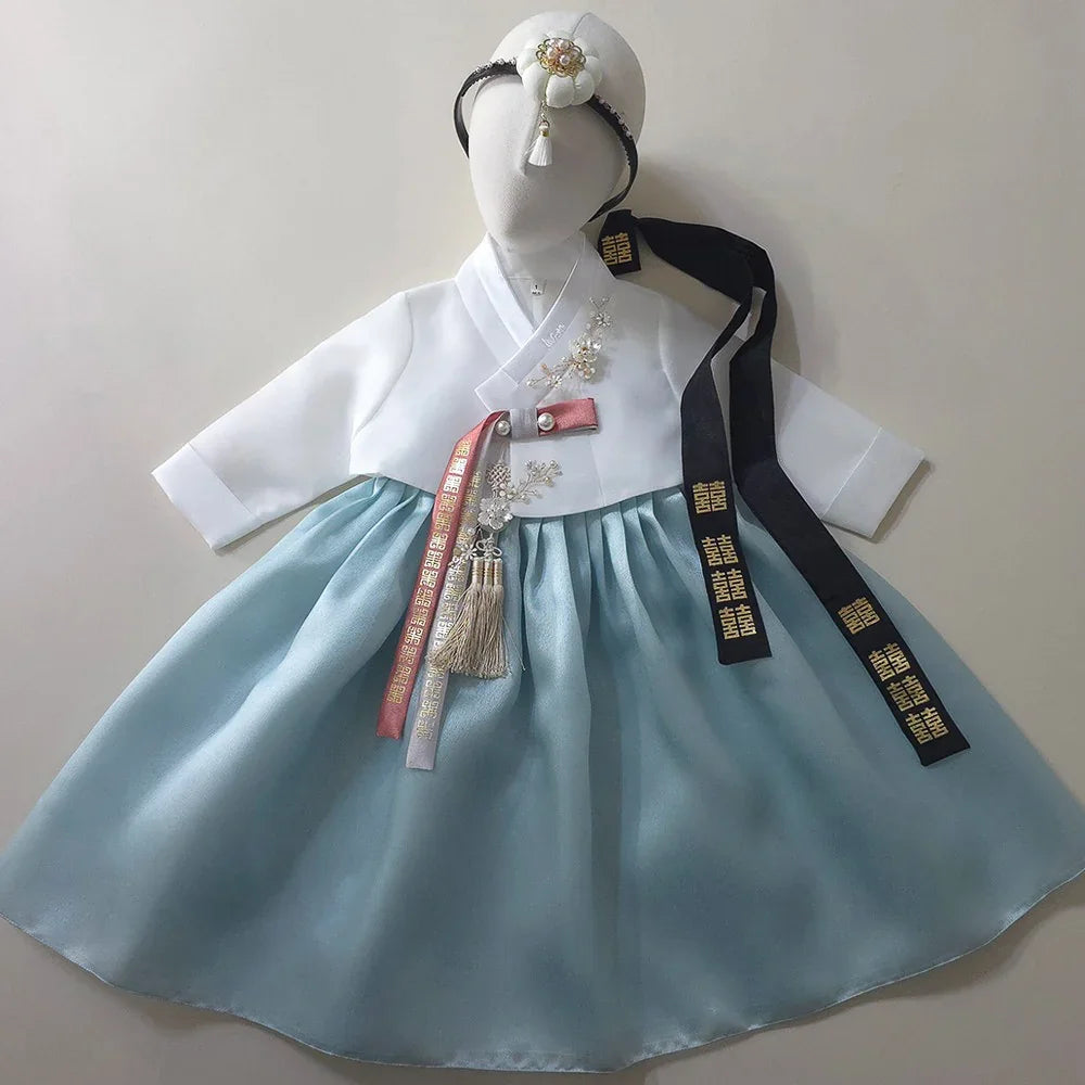 Eunkyo Sky Girl Hanbok by Native Korean with white jeogori, sky blue chima, and jobawi.