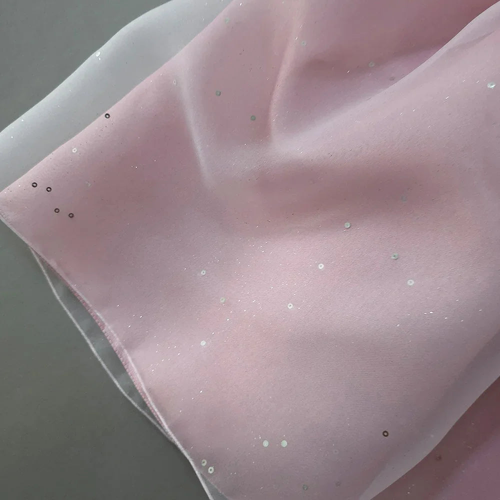 Close-up of pearl pink Girl Hanbok fabric with subtle shimmering sequins.